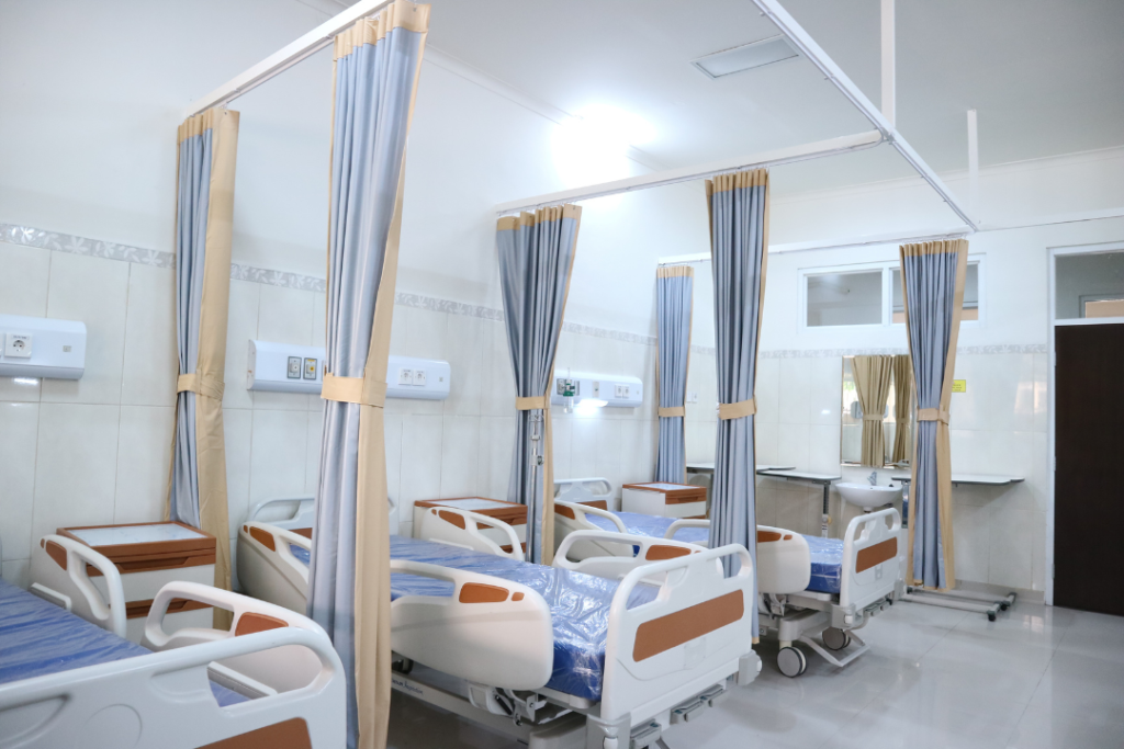 line of hospital beds in emergency room